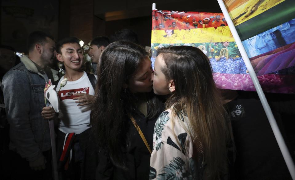 Same sex couples attend a "Kiss-a-thon," as a form of protest for LGBT rights in Bogota, Colombia, Wednesday, April 17, 2019. The event was held at the same Andino shopping mall where days ago two gay men were harassed by a customer who lured police into fining them for "exhibitionism." (AP Photo/Fernando Vergara)