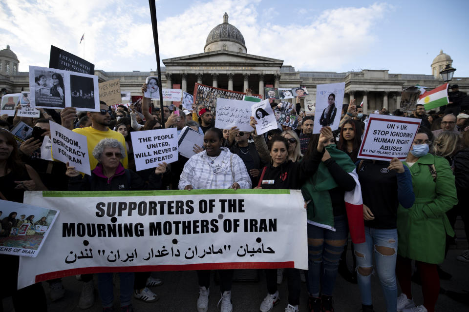 LONDON, UNITED KINGDOM - 2022/09/24: Protesters seen holding a banner and placards during the demonstration at Trafalgar Square. Iranians and feminists gathered to protest against the Iranian Government in regards to the recent death of Mahsa Amini, a 22-year-old woman who was allegedly tortured to death by Iran's morality police for not wearing her hijab properly. (Photo by Hesther Ng/SOPA Images/LightRocket via Getty Images)