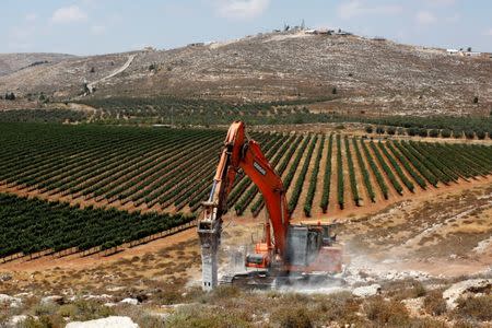 Heavy machinery work on a field as they begin construction work of Amichai, a new settlement which will house some 300 Jewish settlers evicted in February from the illegal West Bank settlement of Amona, in the West Bank June 20, 2017. REUTERS/Ronen Zvulun