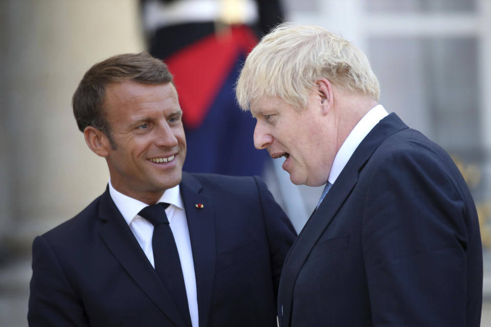 French President Emmanuel Macron bids farewell to Britain's Prime Minister Boris Johnson at the Elysee Palace, Thursday, Aug. 22, 2019 in Paris. Boris Johnson traveled to Berlin Wednesday to meet with Chancellor Angela Merkel before heading to Paris to meet with French President Emmanuel Macron. (AP Photo/Daniel Cole)