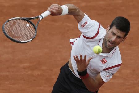 Tennis - French Open - Roland Garros - Novak Djokovic of Serbia vs Steve Darcis of Belgium - Paris, France - 26/05/16. Djokovic serves. REUTERS/Gonzalo Fuentes