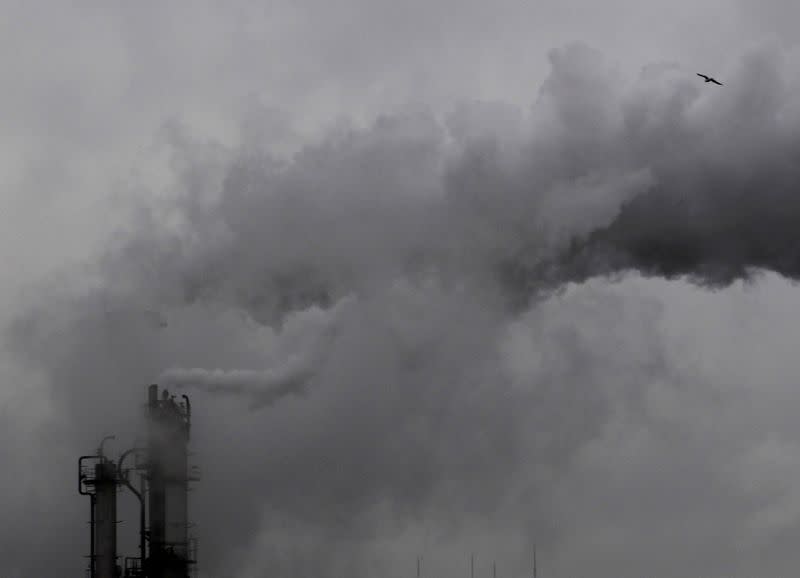 FILE PHOTO: Smoke billows from chimneys at an industrial district near Tokyo