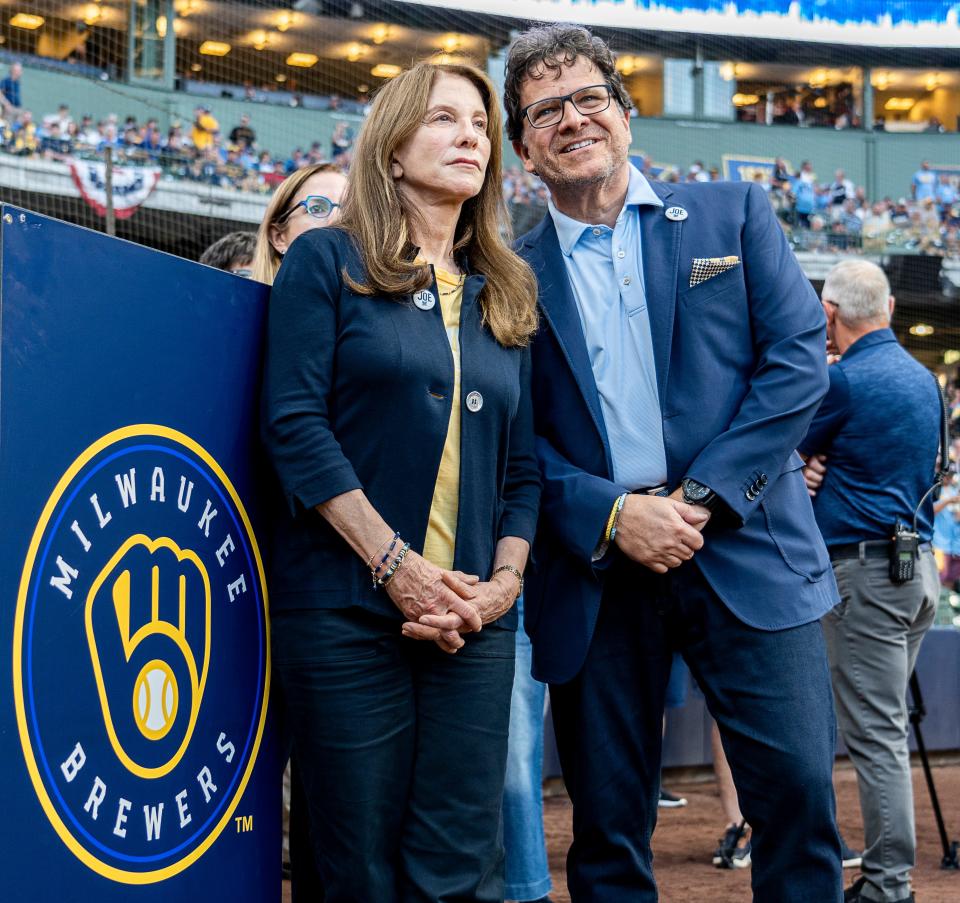 Milwaukee Brewers owner Mark Attanasio and his wife Deborah Attanasio watch the Milwaukee Brewers enter the field for the wildcard playoff game against the Arizona Diamondbacks on October 3, 2023 at American Family Field.