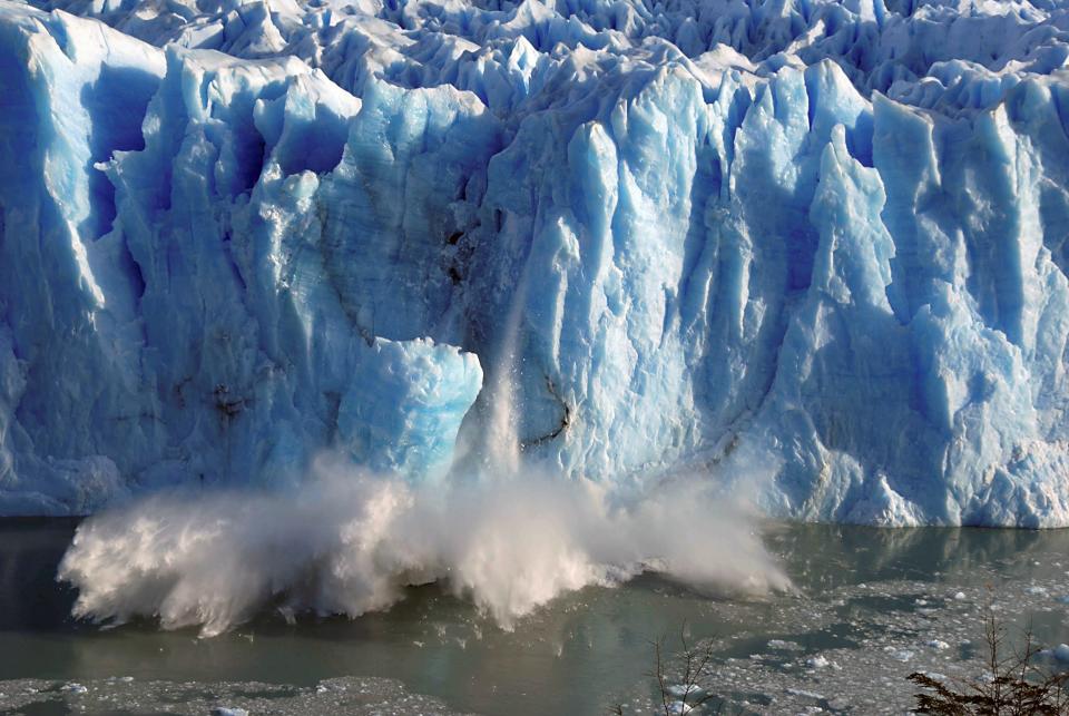 glacier calf ice particles falling into the ocean