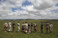 Initiates pose as they walk on a field in Qunu, in the Eastern Cape December 15, 2013. Every year, thousands of youths leave their parents to spend weeks in the care of traditional leaders at an initiation school where they are circumcised, a rite of passage commonly referred to as "Ukwaluka" or "going to the mountain". Former South African President Mandela, who died on December 5 aged 95, will be buried in his family homestead in Qunu on Sunday after a state funeral. REUTERS/Siegfried Modola (SOUTH AFRICA - Tags: SOCIETY)