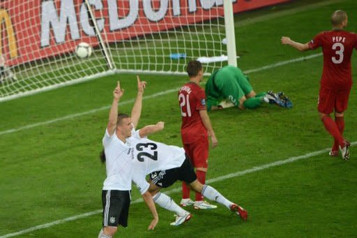 German forward Lukas Podolski (L) celebrates a goal by German forward Mario Gomez (C) as during the Euro 2012 football match at the Arena Lviv. Germany won 1-0