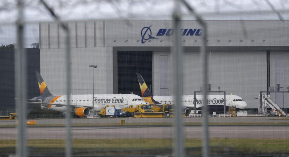 Two Thomas Cook aircraft on the tarmac at Gatwick Airport, England, Monday, Sept. 23, 2019. British tour company Thomas Cook collapsed early Monday after failing to secure emergency funding, leaving tens of thousands of vacationers stranded abroad. (AP Photo/Alastair Grant)