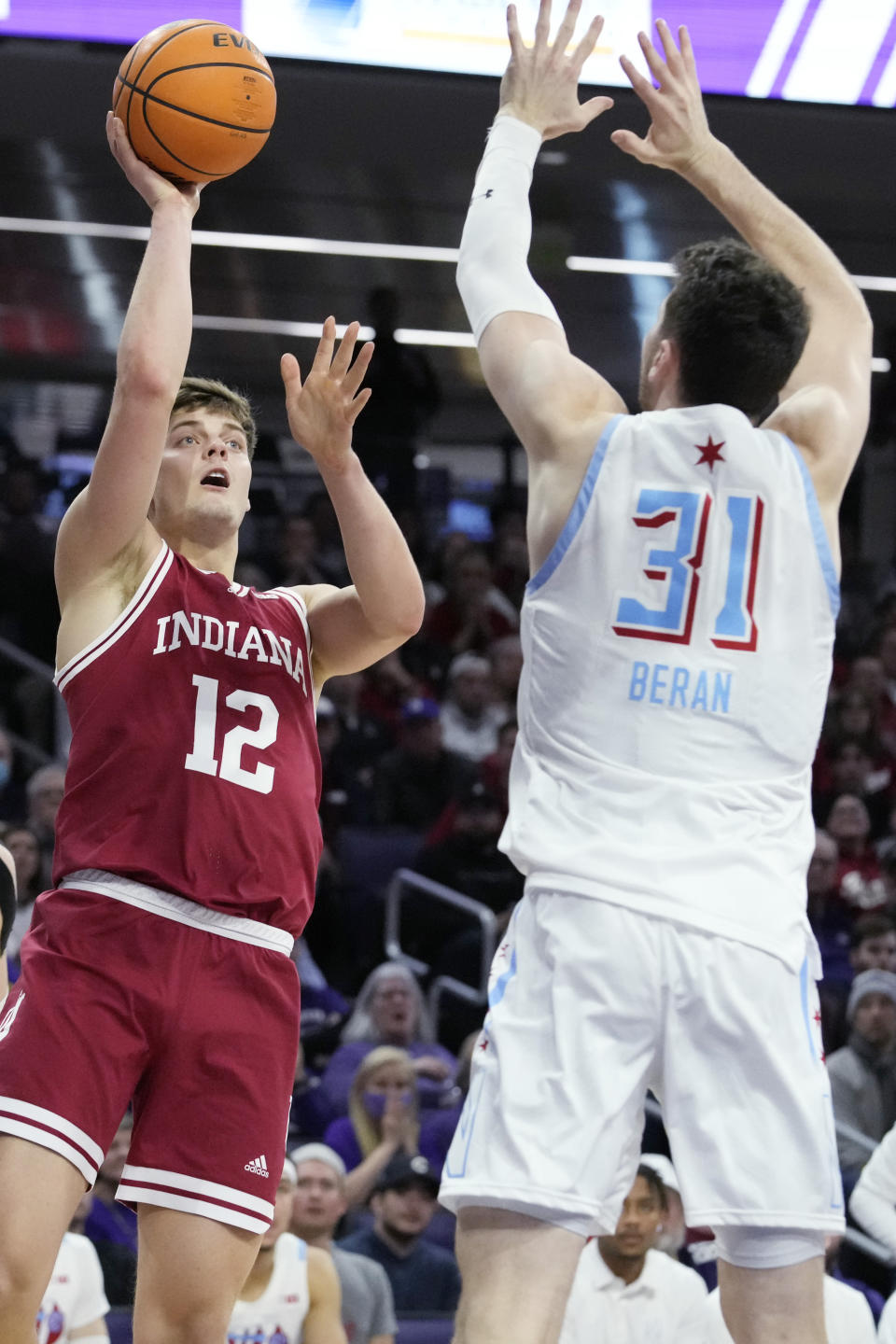 Indiana forward Miller Kopp, left, shoots over Northwestern forward Robbie Beran during the first half of an NCAA college basketball game in Evanston, Ill., Wednesday, Feb. 15, 2023. (AP Photo/Nam Y. Huh)