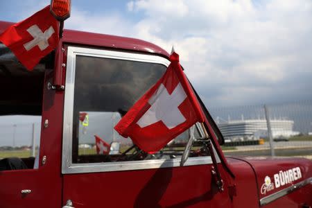 Three Swiss fans arrive in an old-time tractor from home to Kaliningrad stadium, to watch their team playing against Serbia, in Kaliningrad, Russia June 21, 2018. REUTERS/Mariana Bazo