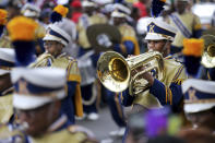 The John F. Kennedy Senior High School Marching Band plays as they march down Jackson Avenue on Mardi Gras Day in New Orleans, Tuesday, Feb. 25, 2020. (AP Photo/Rusty Costanza)