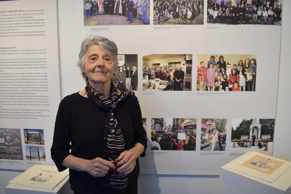 Martha Jamgochian, board chair for the Armenian Historical Association of Rhode Island, stands in front of an exhibit in the association's museum.