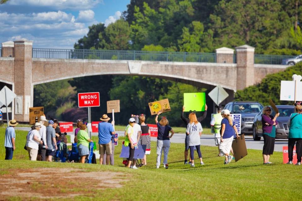 People line up along U.S. 278 ahead of a presidential campaign stop on Friday, June 2, 2023, at Okatie Ale House in Bluffton.