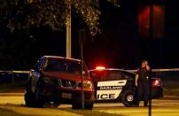 A police officer stands near a vehicle after a shooting outside the Muhammad Art Exhibit and Contest sponsored by the American Freedom Defense Initiative in Garland, Texas May 3, 2015. Two gunmen who opened fire on Sunday at the anti-Islam art exhibit near Dallas featuring depictions of the Prophet Mohammad were themselves shot dead at the scene, a local CBS television affiliate and other local media reported, citing police. REUTERS/Mike Stone