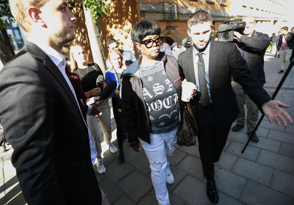 Renee Black, centre, mother of American rapper A$AP Rocky, leaves the district court in Stockholm, following the second day of testimony Thursday Aug. 1, 2019. Pleading not guilty American rapper A$AP Rocky testified in court Thursday, as he stands on charges of assault.(Fredrik Persson / TT via AP)