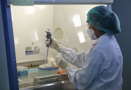 A scientist is testing a sample from the people who is recently returned from South Korea and suspecting of MERS infection. inside a Sample Preparation lab, at the National Institute of Health Department of Medical Sciences in Nonthaburi province, on the outskirts of Bangkok, Thailand, June 18, 2015. REUTERS/Chaiwat Subprasom