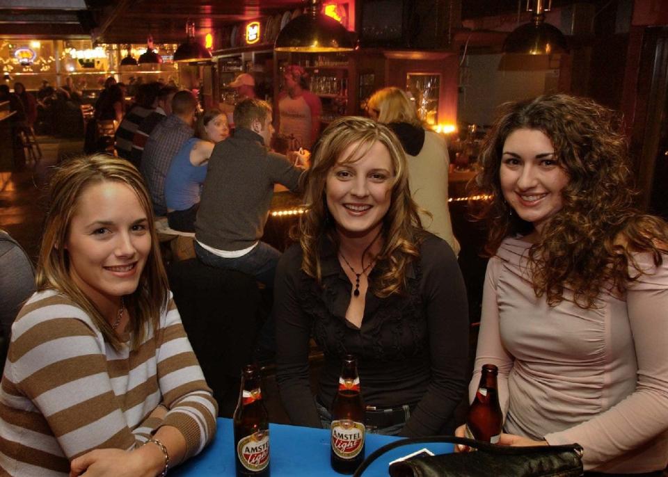 Patrons enjoy beers at R.C.'s on Dec. 27, 2003. The bar closed in 2018.