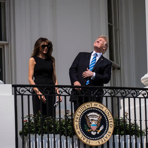 <p>Jabin Botsford/The Washington Post via Getty</p> Then-President Donald Trump looks directly at the 2017 solar eclipse while First Lady Melania Trump wears protective glasses.