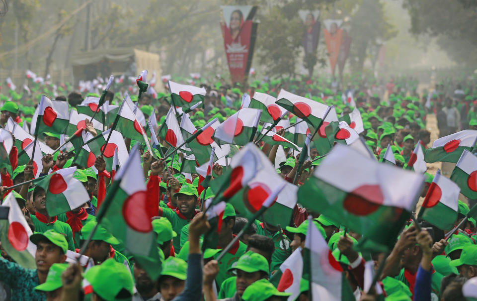 Supporters wave Awami League political party flags during a rally celebrating the party's overwhelming victory in last month's election in Dhaka, Bangladesh, Saturday, Jan. 19, 2019. (AP Photo)