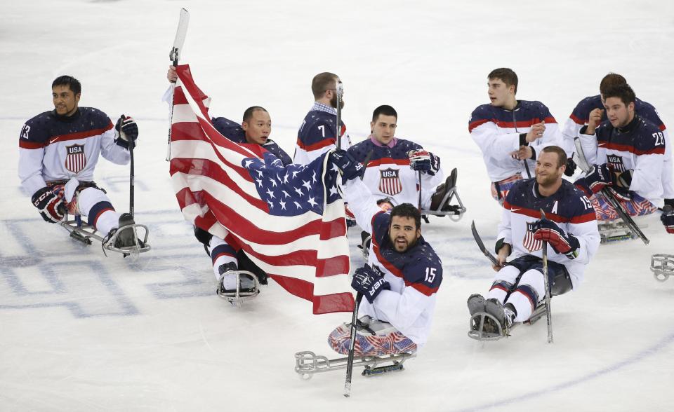 United States players celebrate as they win the gold medal after their ice sledge hockey match against Russia at the 2014 Winter Paralympics in Sochi, Russia, Saturday, March 15, 2014. United States won 1-0. (AP Photo/Pavel Golovkin)