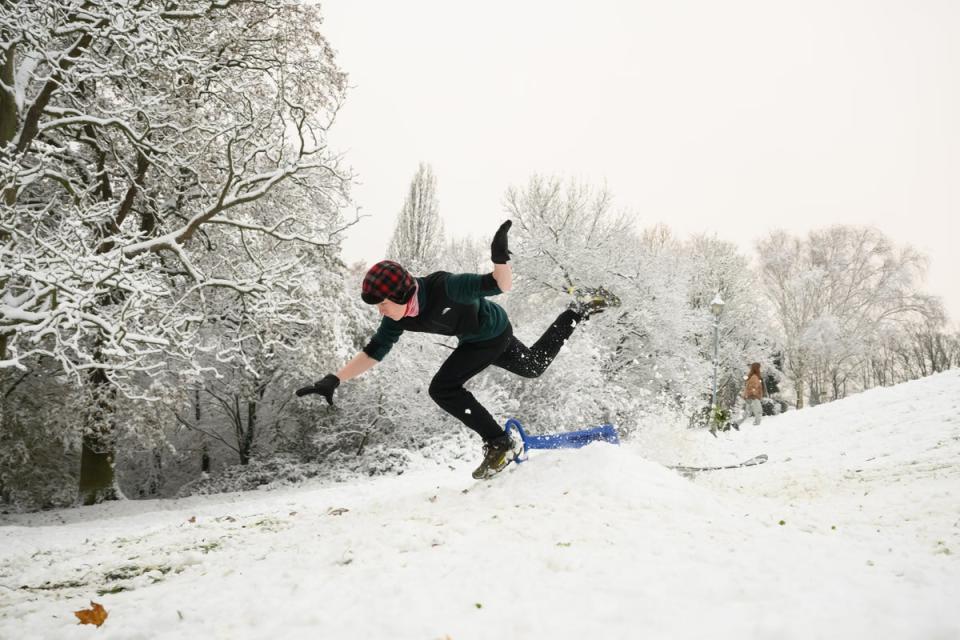 A man takes to the air after hitting a ramp while sledging in Alexandra Palace Park (Getty Images)