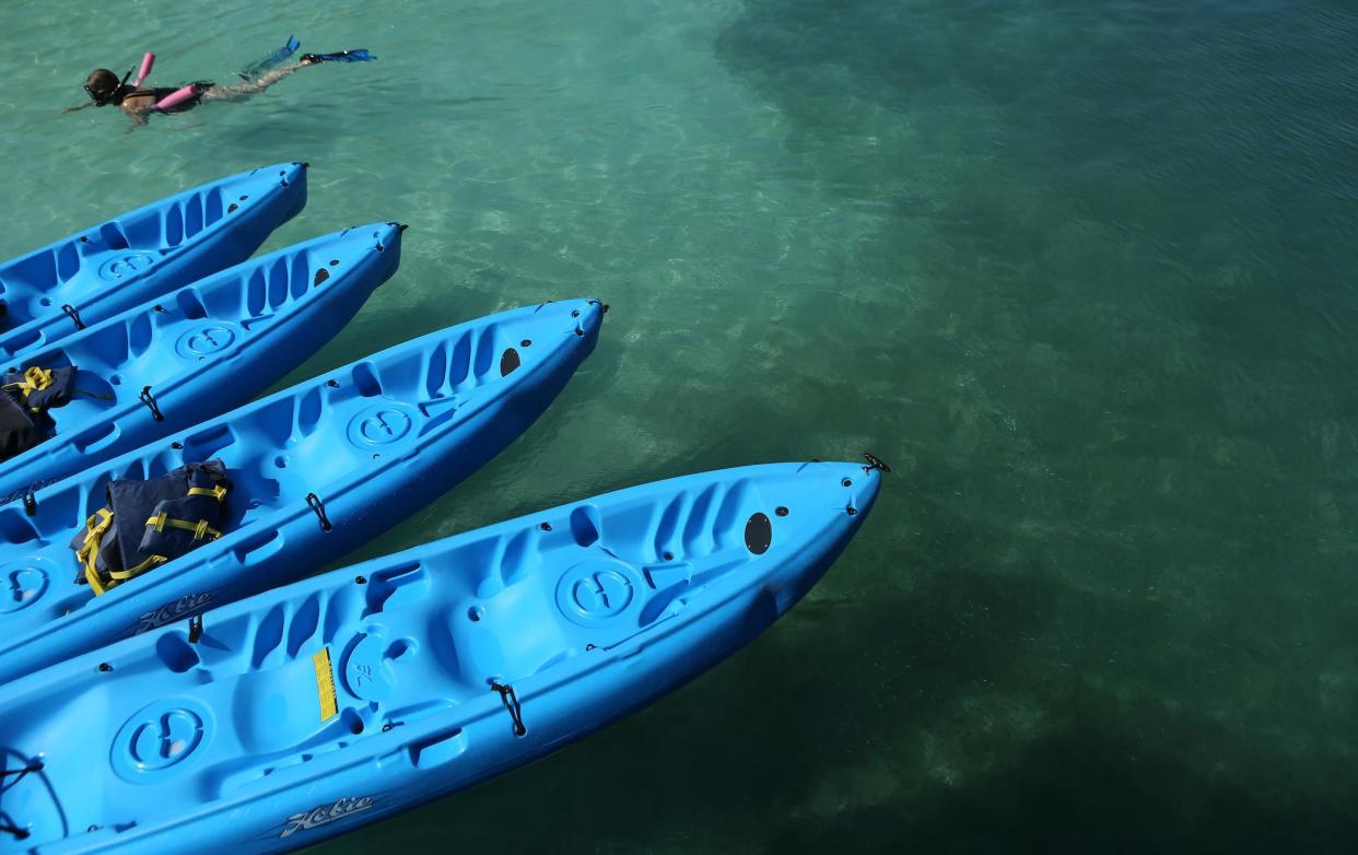 A tourist snorkels in clear waters near a reef July 15, 2013 offshore from Hamilton, Bermuda: REUTERS/Gary Cameron