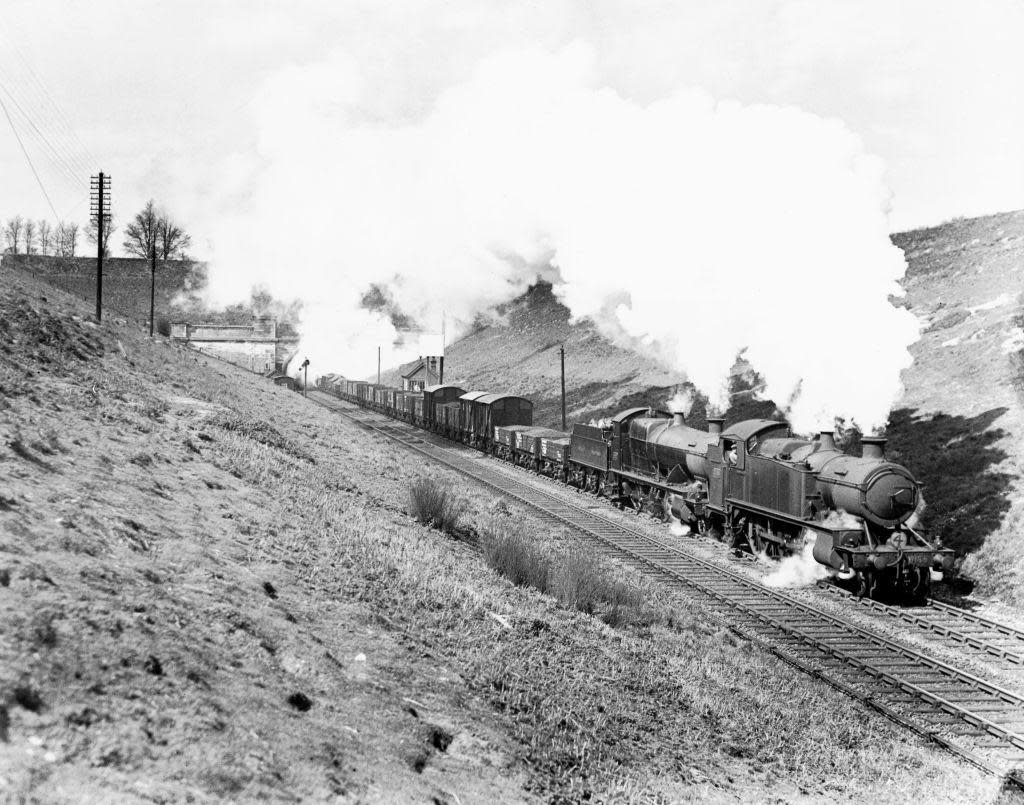 A black and white photo of a steam engine exiting the eastern English end of the Severn