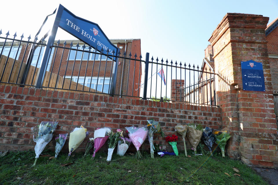 Flowers placed at the entrance to the Holt School, Wokingham, Berskhire, in memory of teacher James Furlong, a victim of the terrorist attack in Forbury Gardens, Reading, on Saturday in which three people died.