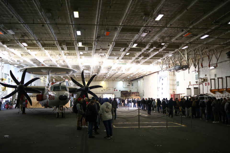 Crew members queue up in the hangar as they wait to disembark the U.S. Aircraft Carrier USS Gerald R. Ford while anchored in the Solent near Gosport, Britain, November 17, 2022. REUTERS/Henry Nicholls