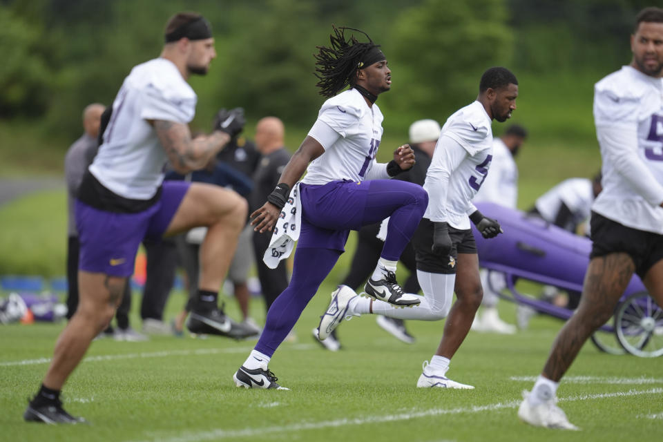 FILE - Minnesota Vikings linebacker Dallas Turner, center, takes part in drills during an NFL football minicamp workout in Eagan, Minn., Thursday, June 6, 2024. Across the NFL, teams wrapped up their mandatory minicamps this week leading into about a month-long break before the start of a grueling NFL season that could approach seven months for the teams that make the Super Bowl. (AP Photo/Abbie Parr, File)