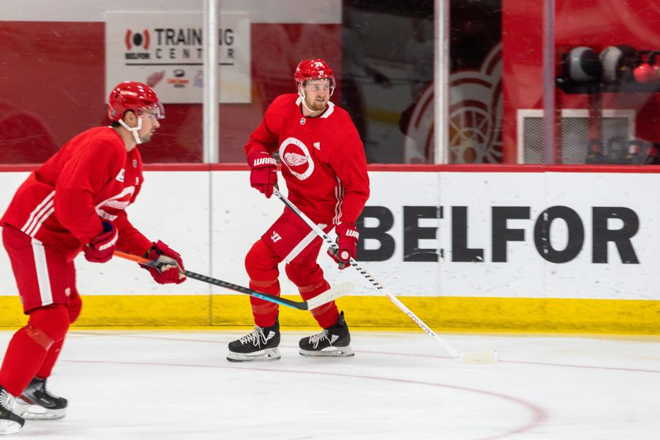 Anthony Mantha, center, and Dylan Larkin skate at Detroit Red Wings training camp practice in Little Caesars Arena, Jan. 2, 2021.