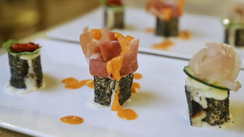 Pizza sushi lined up on white plate