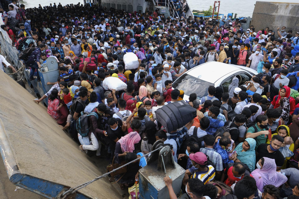 Thousands of people leaving for their native places to celebrate Eid-al-Fitr crowd a ferry at the Mawa terminal ignoring risks of coronavirus infection in Munshiganj, Bangladesh, Thursday, May 13, 2021. (AP Photo/Mahmud Hossain Opu)