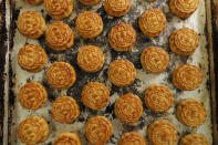 In this Aug. 9, 2019 photo, a tray of mooncakes with Chinese words "Hong Kong people" are seen at Wah Yee Tang bakery in Hong Kong. A Hong Kong bakery is doing its part to support the city’s pro-democracy protest movement by making mooncakes with a message. At Wah Yee Tang, the traditional Chinese harvest festival treat comes with a twist: slogans opposing the city’s Beijing-backed government and promoting Hong Kong’s unique identity that have become popular rallying cries since the protests began two months ago. (AP Photo/Kin Cheung)