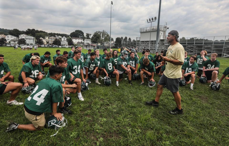 Pleasantville High School head coach Tony Becerra talks to his team at the end of the morning session during the first day of football practice Aug. 21, 2023.
