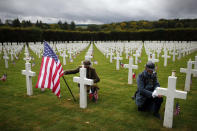 Men in WWI military uniforms pose in the Meuse-Argonne cemetery, northeastern France, during a remembrance ceremony, Sunday, Sept. 23, 2018. A remembrance ceremony is taking place Sunday for the 1918 Meuse-Argonne offensive, America's deadliest battle ever that cost 26,000 lives but helped bringing an end to World War 1. (AP Photo/Thibault Camus)