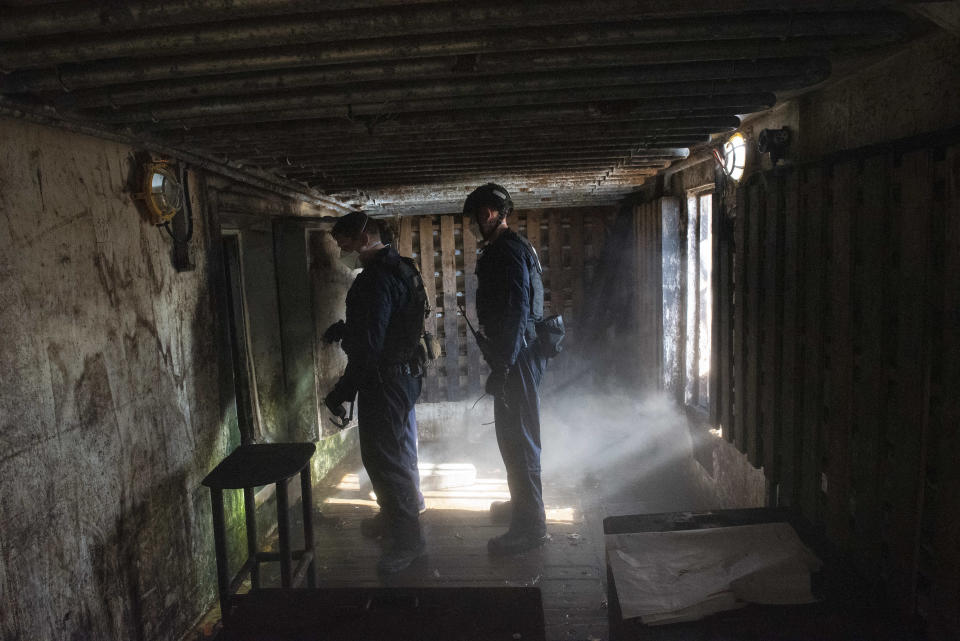 In this photo made available by the U.S. Coast Guard, guardsmen from the cutter James conduct a boarding of a fishing vessel in the eastern Pacific Ocean, on Aug. 4, 2022. During the 10-day patrol for illegal, unreported or unregulated fishing, three vessels steamed away. Another turned aggressively 90 degrees toward the James, forcing the American vessel to maneuver to avoid being rammed. (Petty Officer 3rd Class Hunter Schnabel/U.S. Coast Guard via AP)