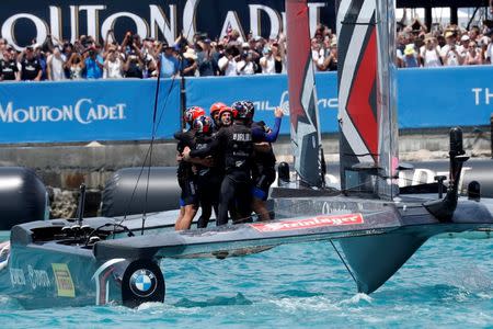 Sailing - America's Cup finals - Hamilton, Bermuda - June 26, 2017 - Peter Burling, Emirates Team New Zealand Helmsman celebrates with his team after defeating Oracle Team USA in race nine to win the America's Cup. REUTERS/Mike Segar