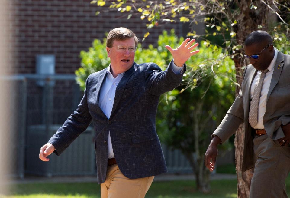 Gov. Tate Reeves waves to students while walking into the Bolton-Edwards Elementary Middle School in Bolton, Miss., Tuesday, Aug. 22, 2023, for a Comcast celebration of the completion of broadband extension to Bolton and Edwards. During the program, Comcast gave every child in the school a free laptop to celebrate.