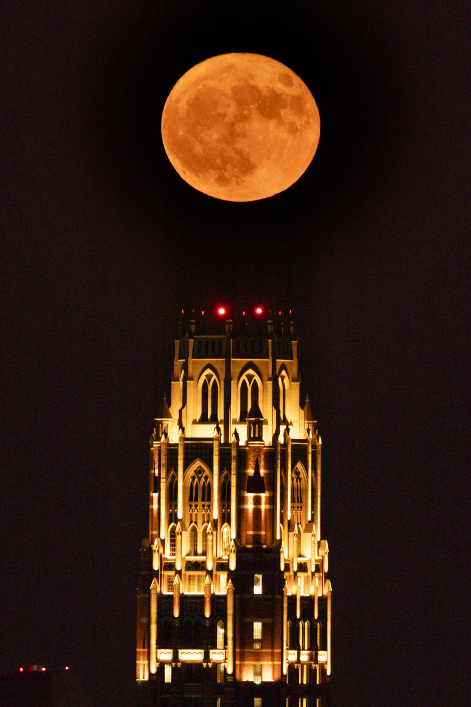 A supermoon rises over the West End Tower at Vanderbilt University, Tuesday, Aug. 1, 2023, in Nashville, Tenn. The Sturgeon moon is the second of four supermoons to appear in 2023. (AP Photo/George Walker IV)