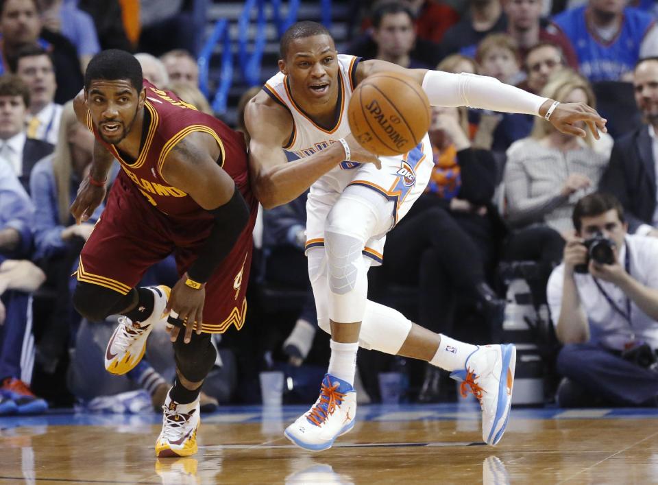 Cleveland Cavaliers guard Kyrie Irving, left, and Oklahoma City Thunder guard Russell Westbrook watch the ball during the second quarter of an NBA basketball game in Oklahoma City, Wednesday, Feb. 26, 2014. (AP Photo/Sue Ogrocki)