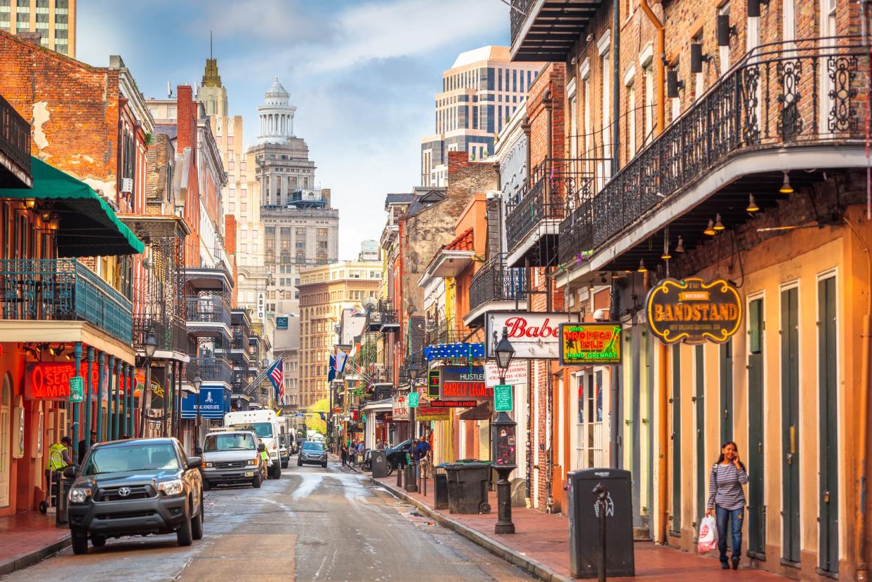 New Orleans, Louisiana, USA - May 10, 2016: Traffic and pedestrians on Bourbon Street in the day. The historic street is the heart of the French Quarter.