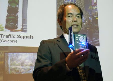 File picture of inventor Shuji Nakamura displaying one of his blue light inventions before a press conference at the University of California in Santa Barbara, California June 15, 2006. REUTERS/Phil Klein/Files