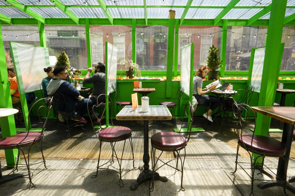 FILE - In this May 4, 2021, file photo, lunch hour customers are seen in an outdoor seating area of a restaurant in the Greenwich Village neighborhood of Manhattan in New York. Teams of experts are projecting COVID-19's toll on the U.S. will fall sharply by the end of July, according to research released by the government Wednesday, May 5. (AP Photo/Mary Altaffer, File)