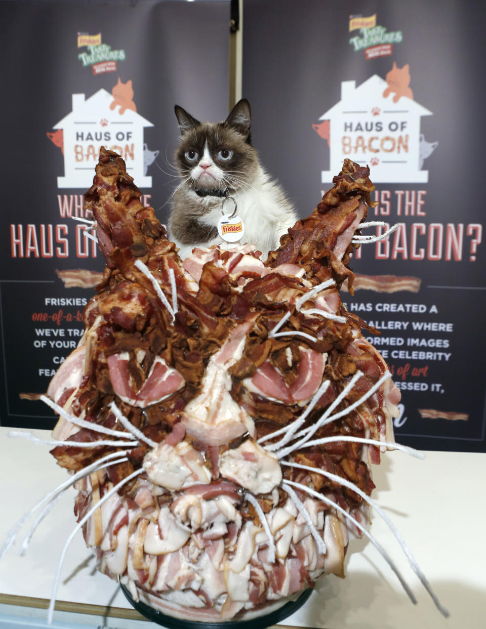 IMAGE DISTRIBUTED FOR FRISKIES - Friskies' &amp;quot;official spokescat&amp;quot; Grumpy Cat poses with a custom sculpture made entirely of bacon by pop artist Jason Mecier at the &amp;quot;Haus of Bacon&amp;quot; presented by NEW Friskies&amp;#174; Tasty Treasures&amp;#174; Accented With Real Bacon during the popular Austin-based festival on Sunday, March 15, 2015 in Austin, TX. Thanks to fan support through use of the hashtag #CatDreamsComeTrue, Friskies&amp;#174; donated 50,000 meals of the NEW Tasty Treasures&amp;#174; Accented with Real Bacon to shelter cats. (Erich Schlegel/AP Images for Friskies)