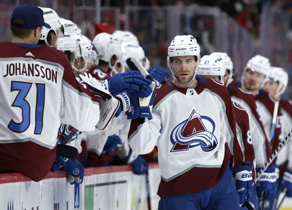 Colorado Avalanche defenseman Devon Toews celebrates with teammates after scoring against the Detroit Red Wings during the first period of an NHL hockey game Saturday, March 18, 2023, in Detroit. (AP Photo/Duane Burleson)