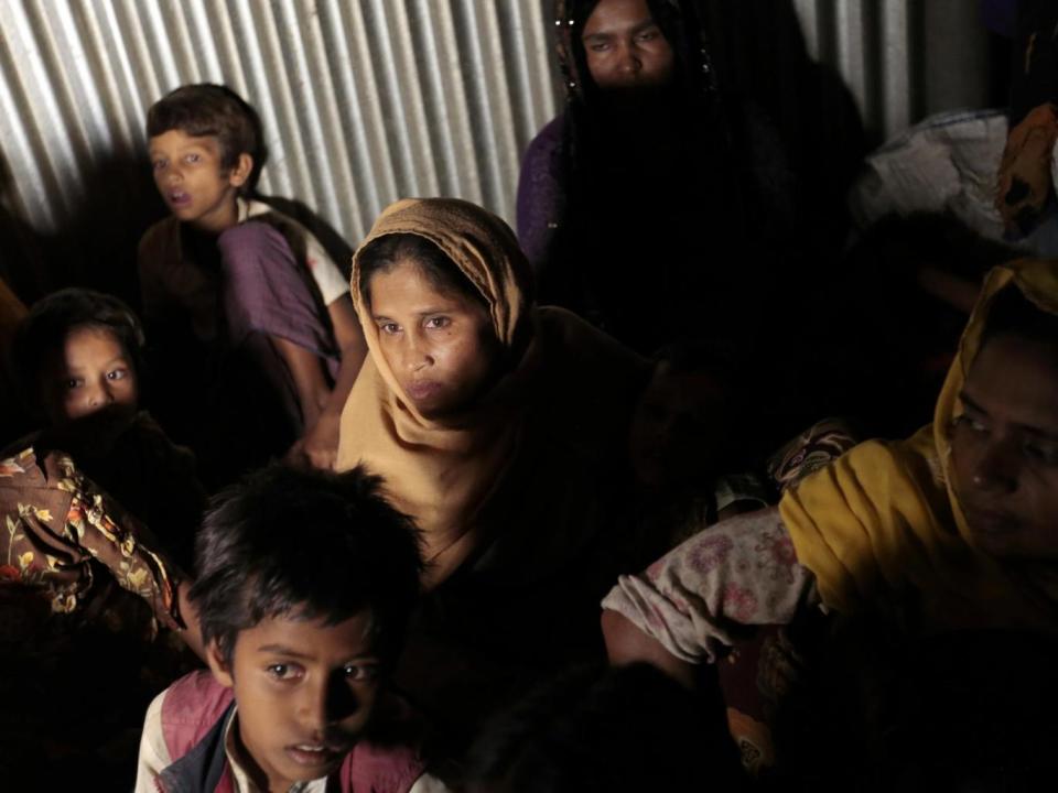 Rohingya Muslims from Myanmar huddle in a room at an unregistered refugee camp south of Dhaka, Bangladesh