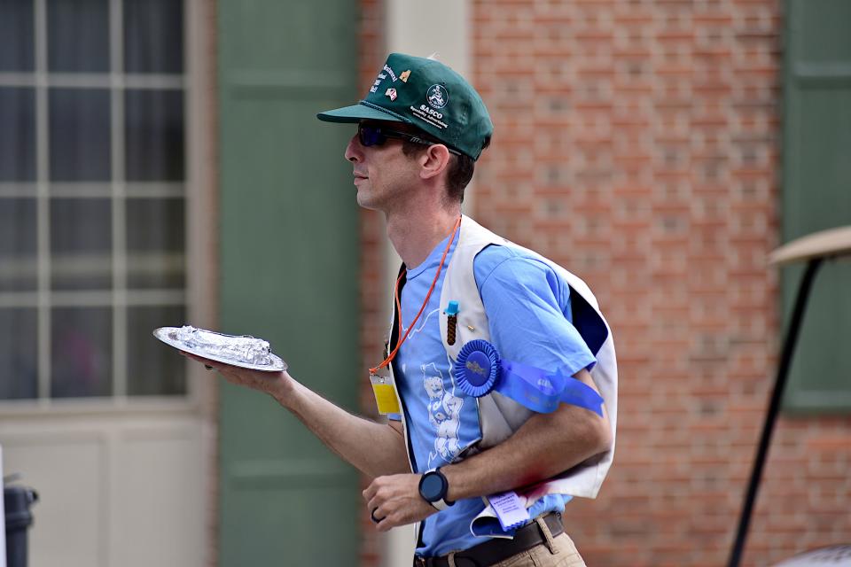 Doug Foght runs the official first sausage of the year to the stage Thursday morning during the opening ceremony for the 2023 Bucyrus Bratwurst Festival.