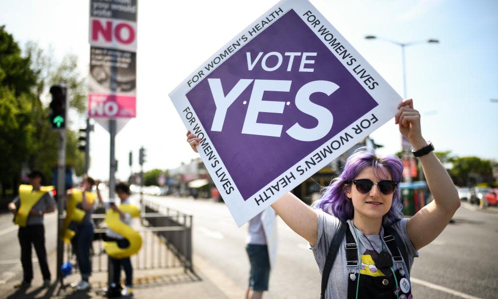 Yes and no supporters campaign next to each other on polling day in Dublin.