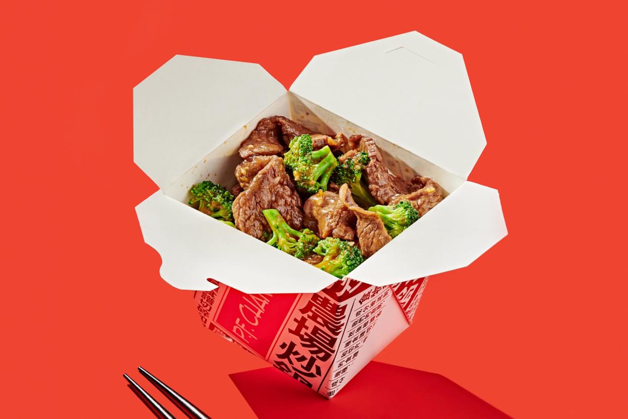 Beef with Broccoli in a takeout container on a red background