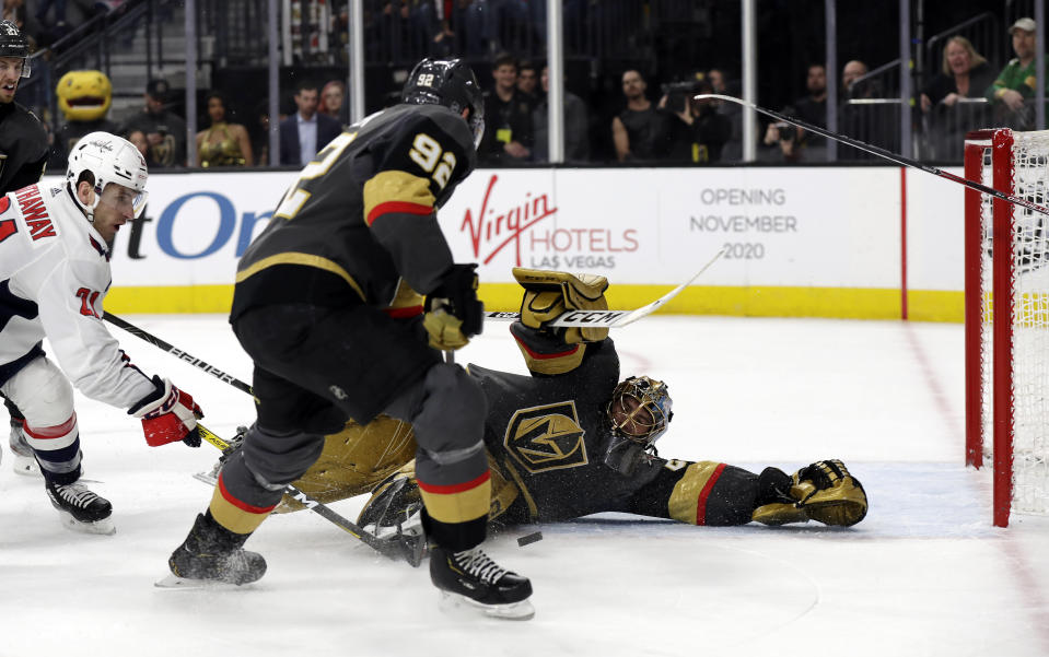 Vegas Golden Knights goalie Marc-Andre Fleury stops a shot from Washington Capitals forward Garnet Hathaway, left, as left wing Tomas Nosek (92) defends during the first period of an NHL hockey game Monday, Feb. 17, 2020, in Las Vegas. (AP Photo/Isaac Brekken)
